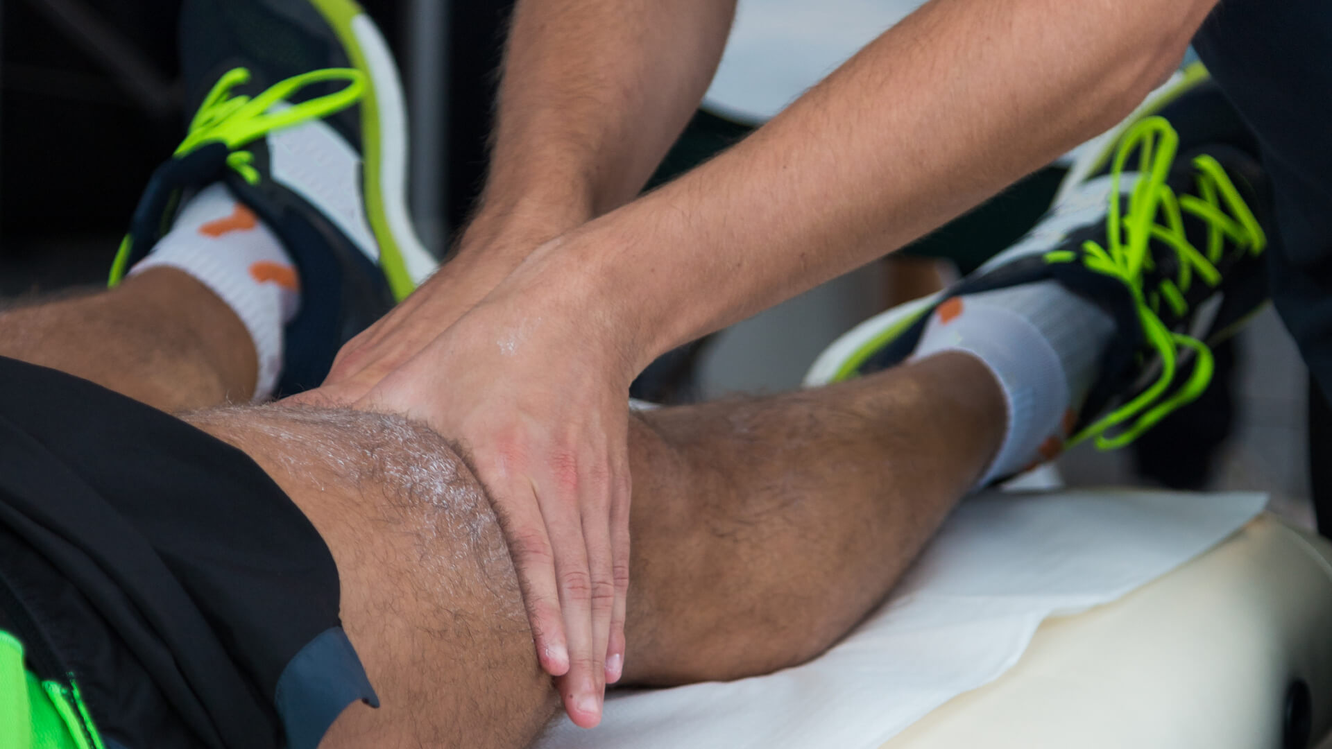 hands providing physiotherapy treatment on athlete knee hands providing physiotherapy treatment on athlete knee